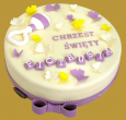 tort z okazji chrztu świętego z biało fioletową grzechotką